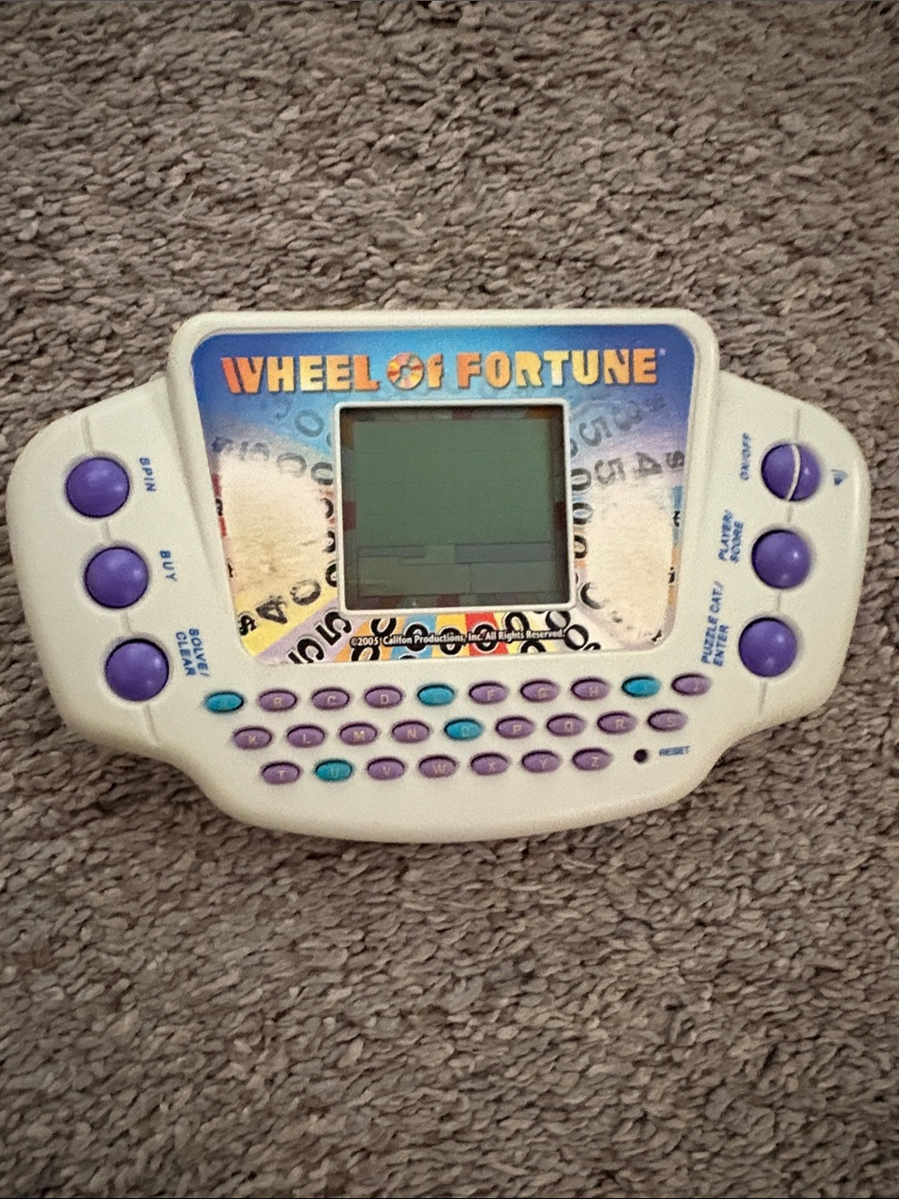 Hasbro Wheel of Fortune Handheld Game - White with Purple & Teal Buttons